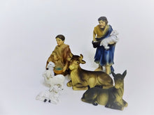 Nativity Scene Shepherds holding lambs. with cows , some of the 15 Nativity Scene figurines. up to 4" tall, hand-painted polyresin.